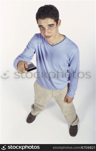 High angle view of a teenage boy holding a remote control