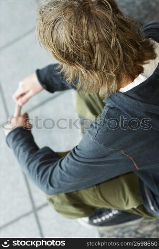 High angle view of a teenage boy sitting