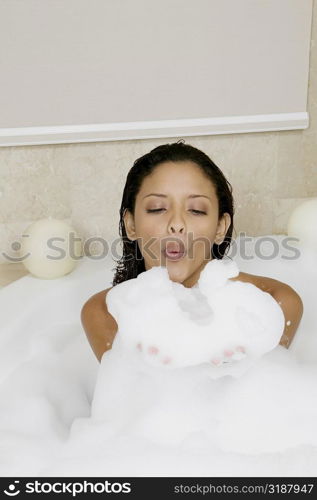 High angle view of a teenage girl blowing soap suds