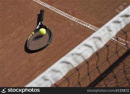 High angle view of a tennis ball on a racket in a court