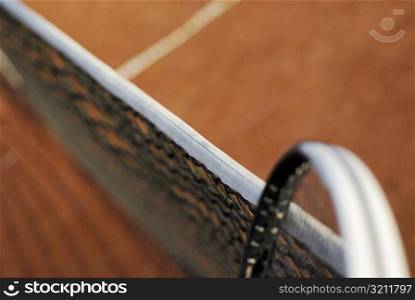 High angle view of a tennis racket and a tennis net on a tennis court