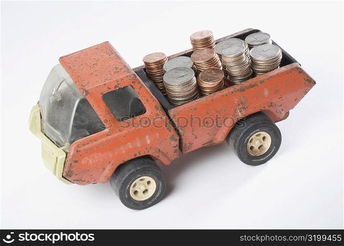 High angle view of a toy truck loading stacks of coins