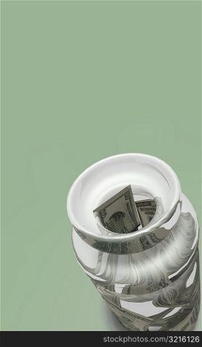 High angle view of a vase stuffed with money