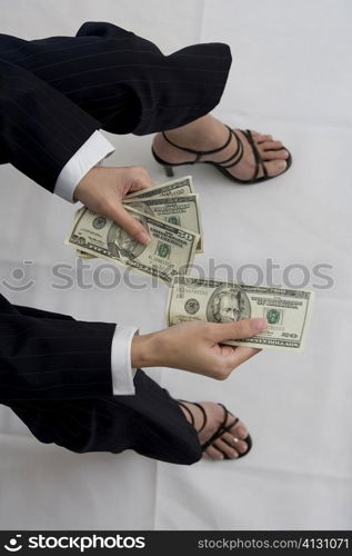 High angle view of a woman holding American dollar bills