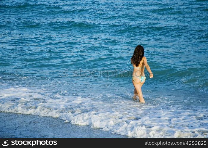 High angle view of a woman walking in water