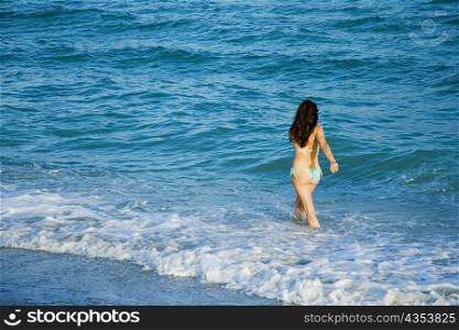 High angle view of a woman walking in water
