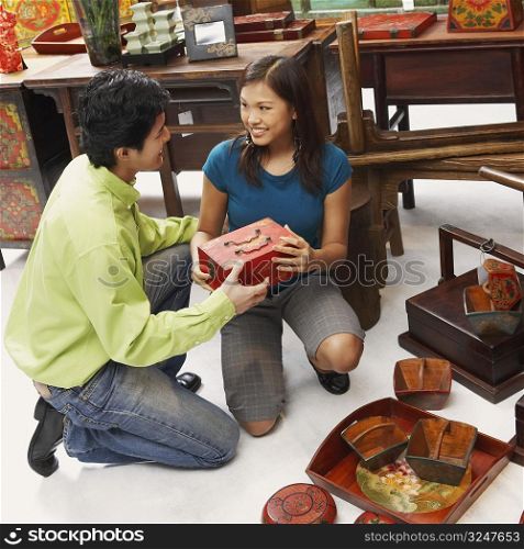 High angle view of a young couple choosing merchandise in a store