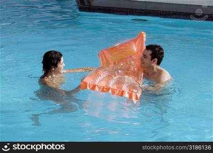 High angle view of a young couple in a swimming pool