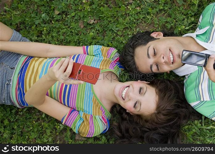 High angle view of a young couple lying in a park