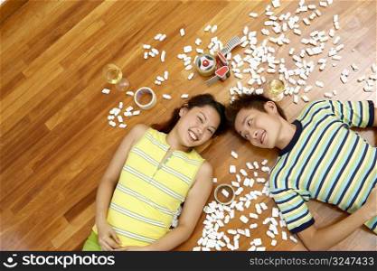 High angle view of a young couple lying on the floor and smiling