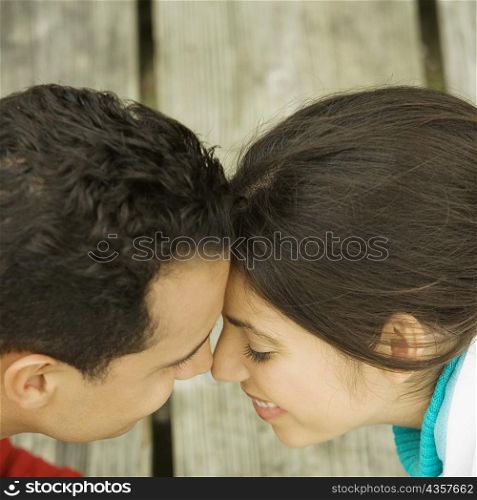 High angle view of a young couple nuzzling