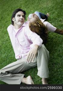 High angle view of a young couple sitting back to back