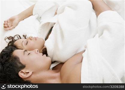 High angle view of a young man and a teenage girl sleeping