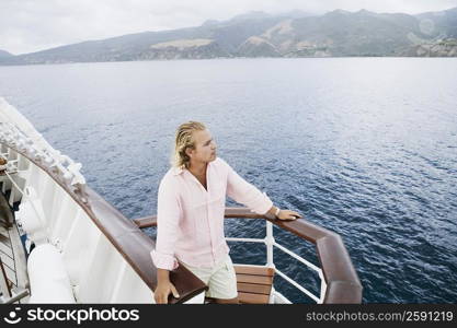 High angle view of a young man standing on a boat deck