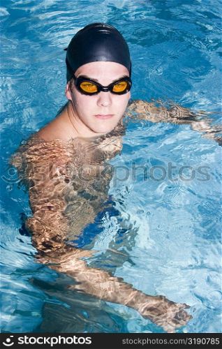 High angle view of a young man swimming in a swimming pool