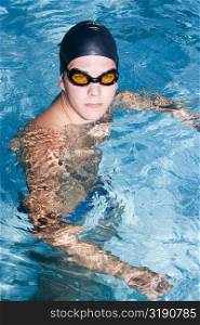 High angle view of a young man swimming in a swimming pool