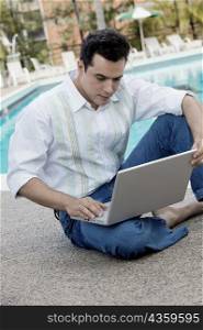 High angle view of a young man using a laptop