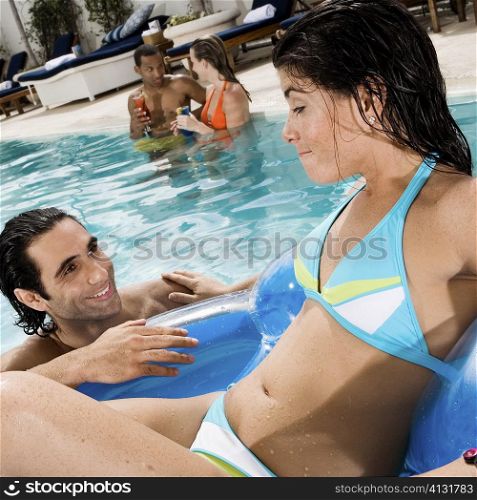 High angle view of a young woman and a mid adult man looking at each other