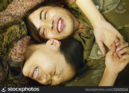 High angle view of a young woman and a mid adult man smiling