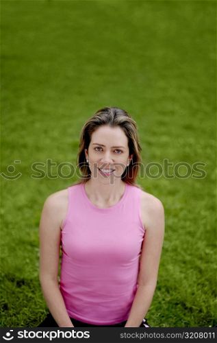 High angle view of a young woman doing yoga in a park