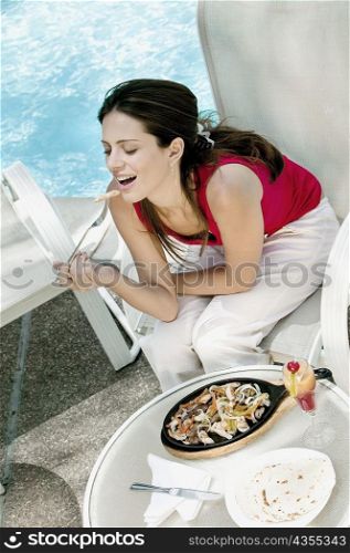 High angle view of a young woman eating food