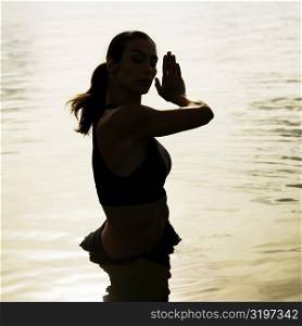 High angle view of a young woman exercising in a lake