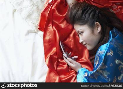 High angle view of a young woman holding a mobile phone