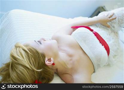 High angle view of a young woman lying on the bed