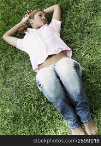 High angle view of a young woman lying on the grass