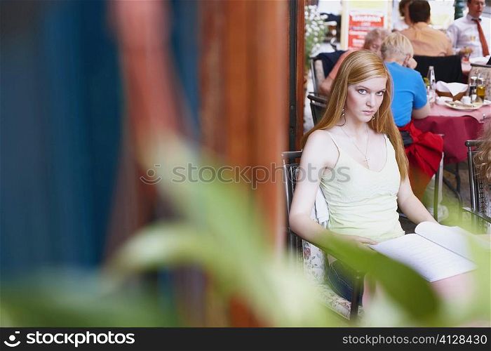 High angle view of a young woman sitting in a cafe