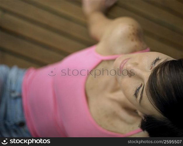 High angle view of a young woman sitting on the hardwood floor