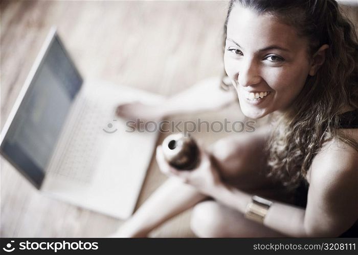 High angle view of a young woman using a laptop