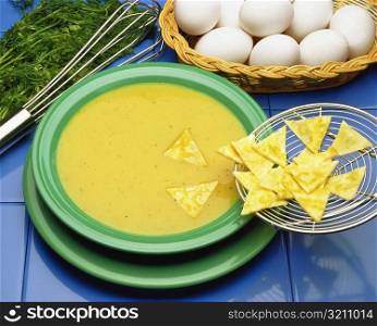 High angle view of bowl of soup with crackers