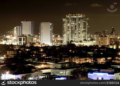 High angle view of buildings in a city lit up at night