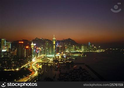 High angle view of buildings in a city lit up at night, Hong Kong, China