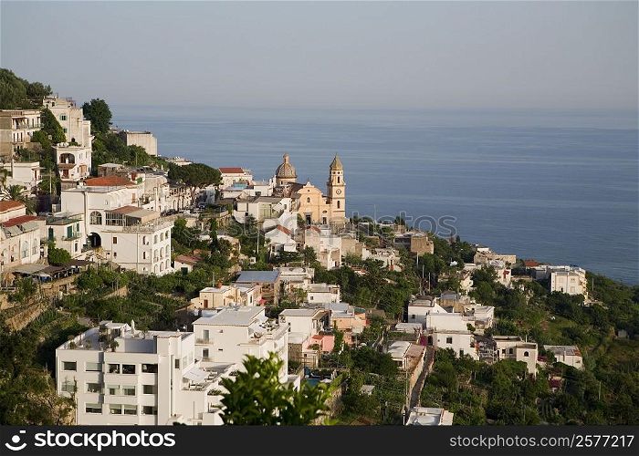 High angle view of buildings in a town with a church in the background, Parrocchiale di San Gennaro, Amalfi Coast, Maiori, Salerno, Campania, Italy
