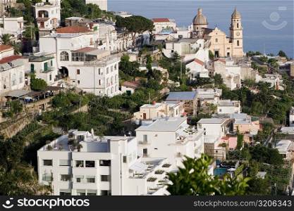 High angle view of buildings in a town with a church in the background, Parrocchiale di San Gennaro, Amalfi Coast, Maiori, Salerno, Campania, Italy