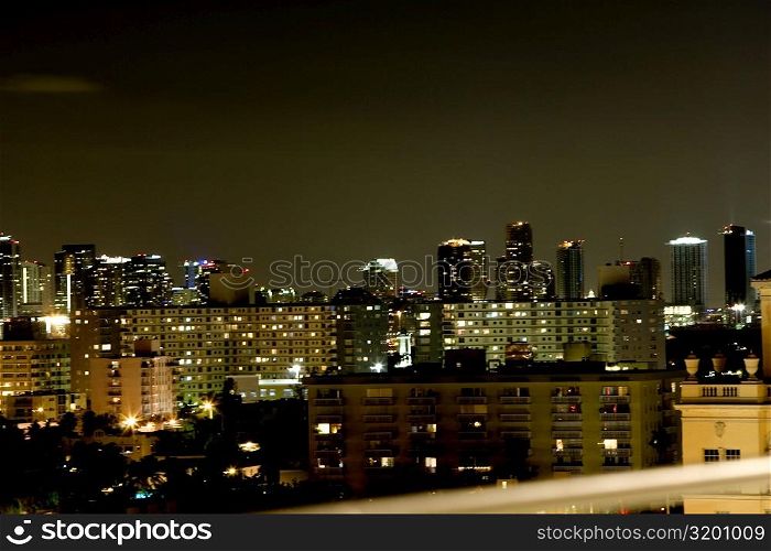 High angle view of buildings lit up at night