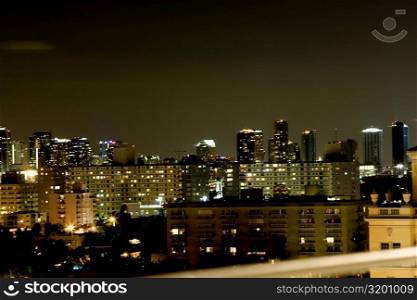 High angle view of buildings lit up at night