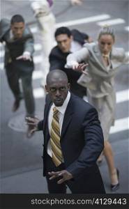 High angle view of business executives chasing a businessman