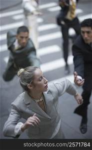 High angle view of business executives chasing a businesswoman