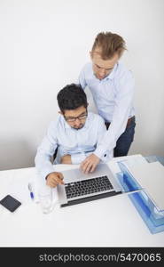 High angle view of businessmen using laptop in office