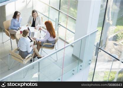 High angle view of businesswomen discussing at table in office