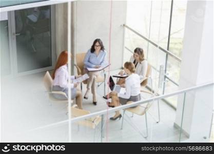 High angle view of businesswomen discussing in office