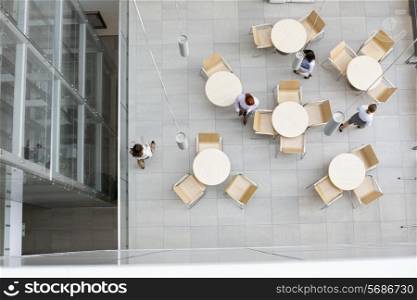High angle view of businesswomen walking at office canteen