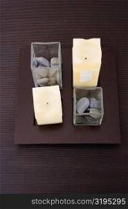 High angle view of candles and pebbles on a table
