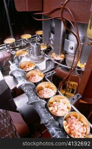 High angle view of canned seafood on an assembly line, Maryland, USA