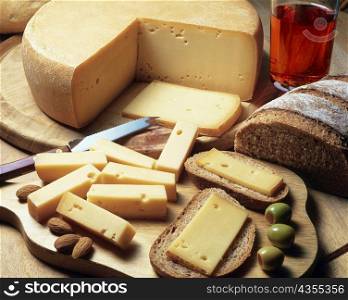 High angle view of cheese with bread and olives