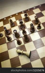 High angle view of chess game with a fallen king