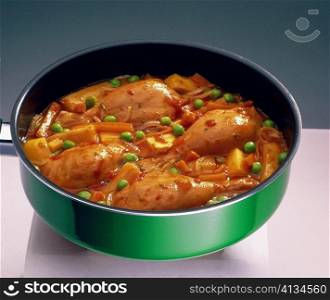 High angle view of chicken legs in a frying pan